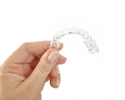 Woman holding clear aligner, wilmington de