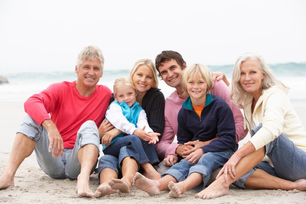 Family smiling together on beach, wilmington de