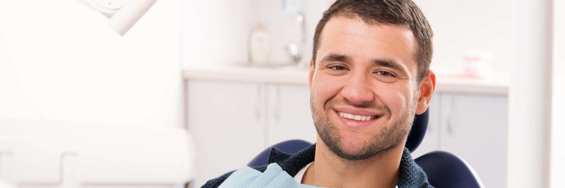 Man smiling in dental chair, wilmington de