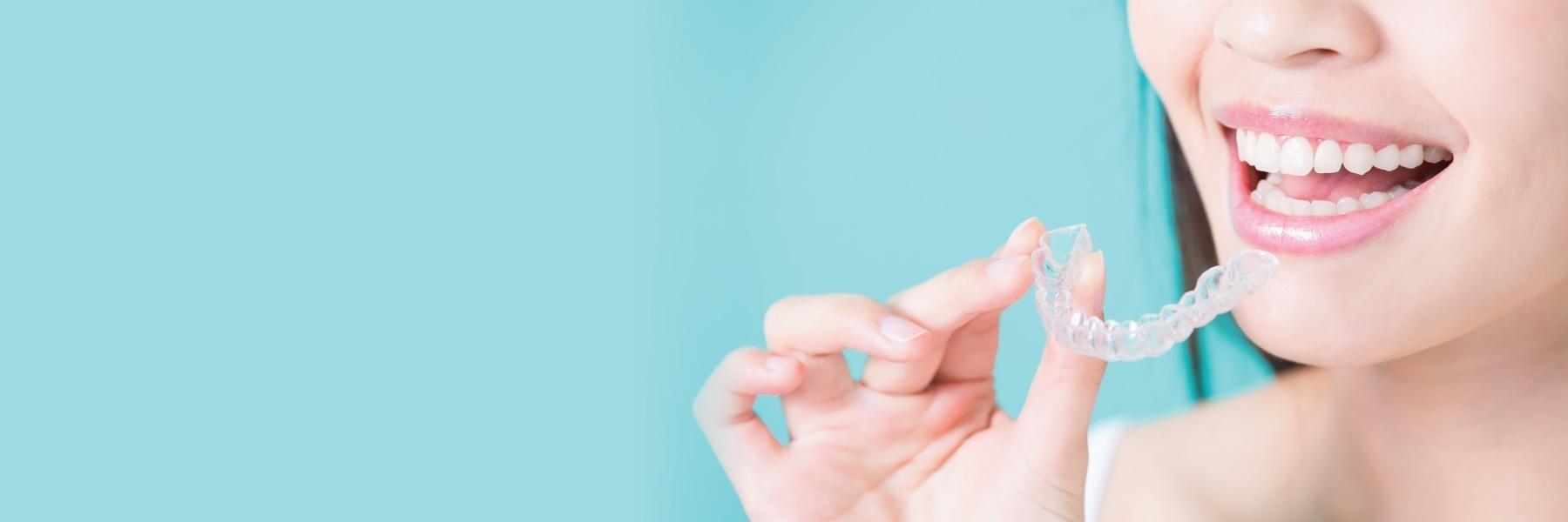 woman putting on Invisalign in wilmington de