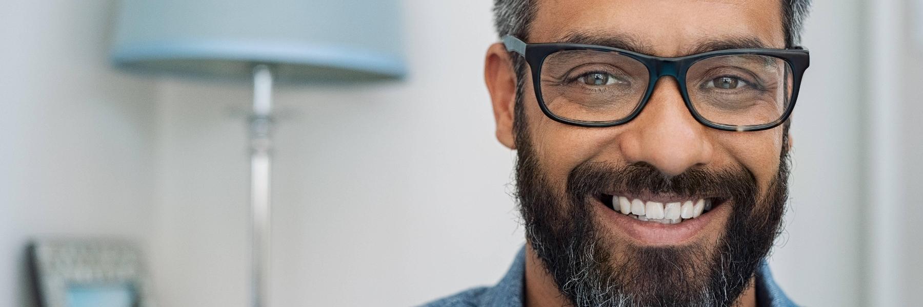 man smiling behind his computer in wilmington de