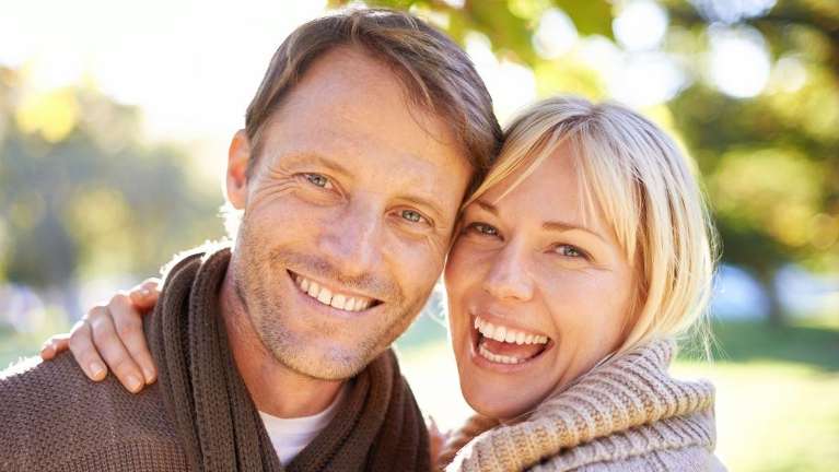 Man and woman smiling after cosmetic dentistry, Wilmington DE