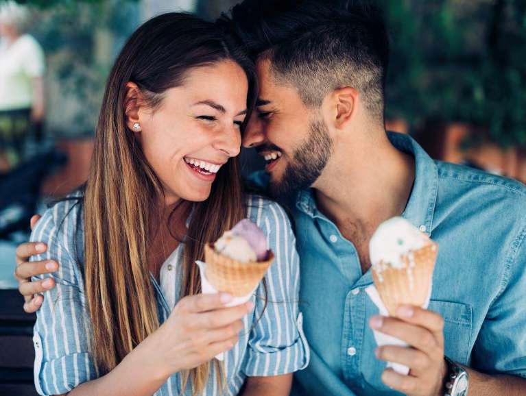 Man and woman holding ice cream cones and smiling, wilmington de