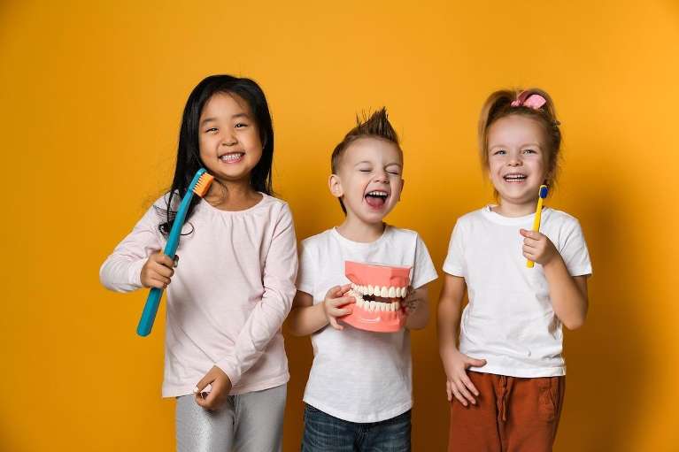 Kids smiling with toothbrushes, wilmington de