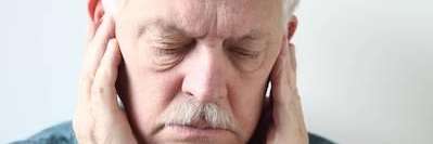 Older man holding his jaw in pain in need of an emergency dentist, wilmington de