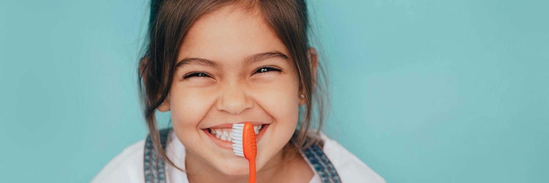 Young girl holding toothbrush, wilmington de