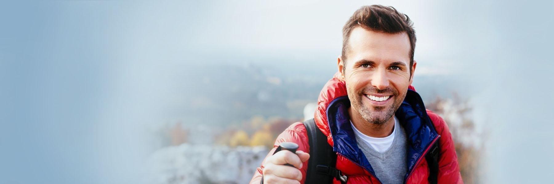 Man smiling on a hike wearing Six Month Smiles in Wilmington DE